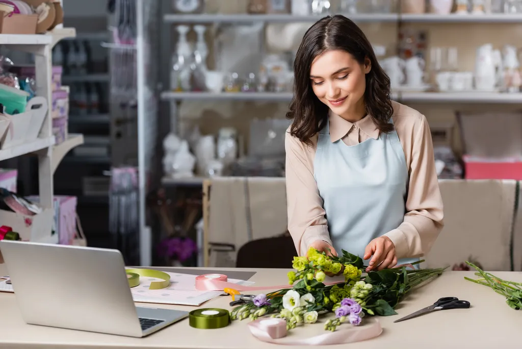 Florist managing her small business website on a laptop